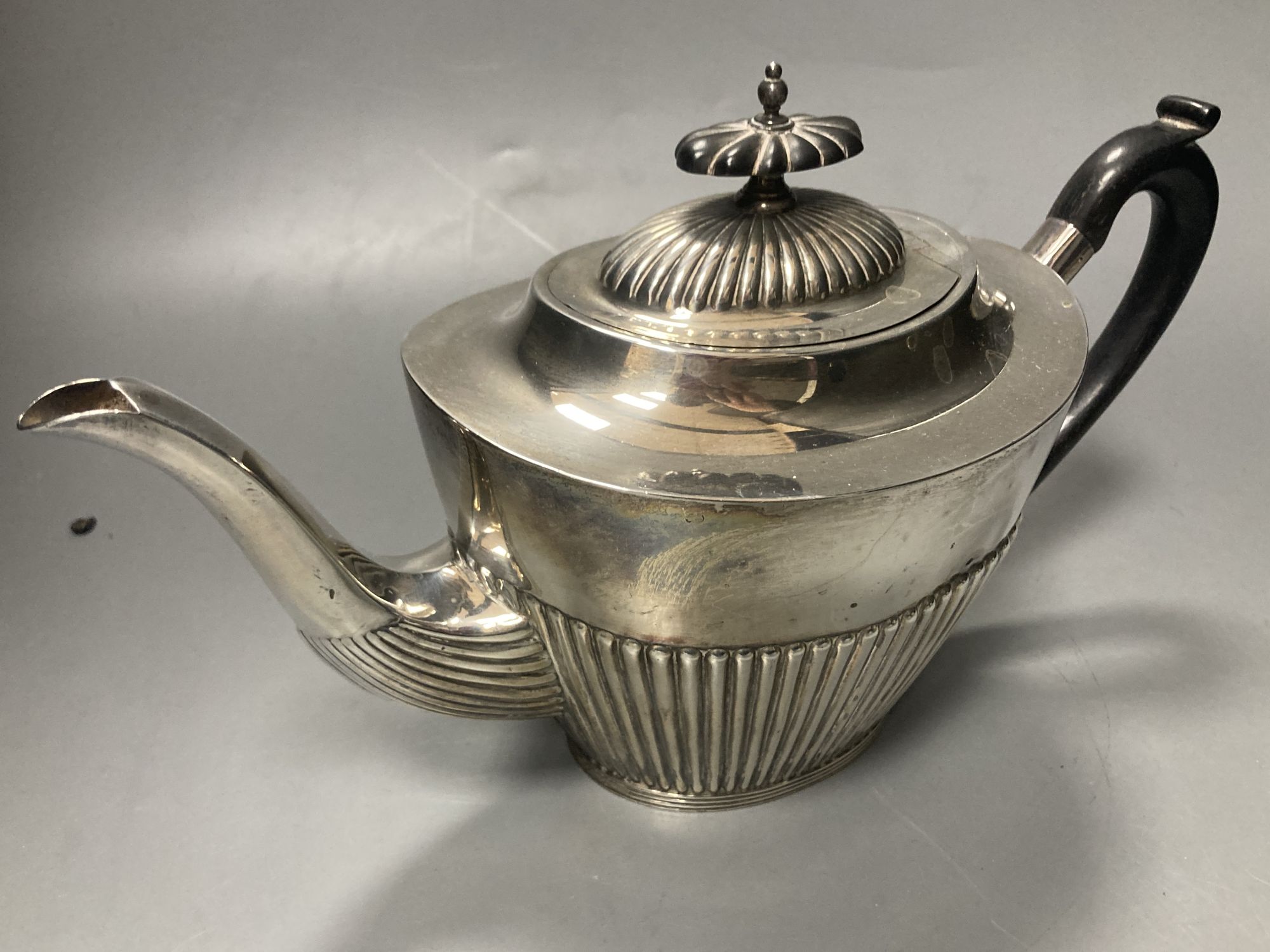 A late Victorian demi fluted silver three piece tea set, Mappin & Webb, Sheffield, 1897 & a matched hot water pot,